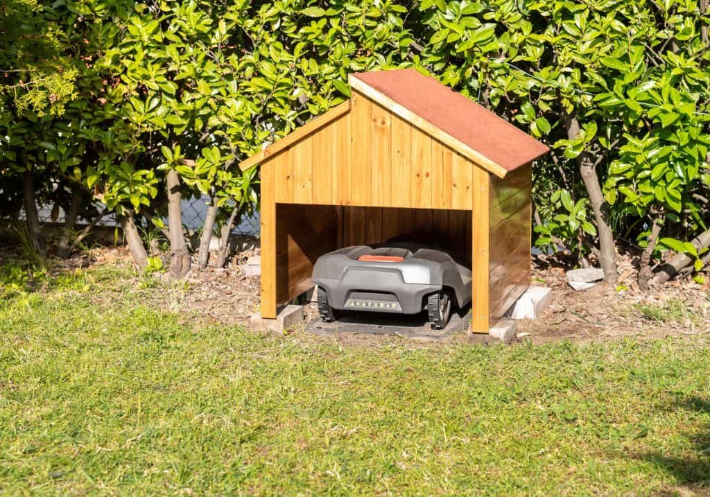 robot lawnmower parked in homemade garage