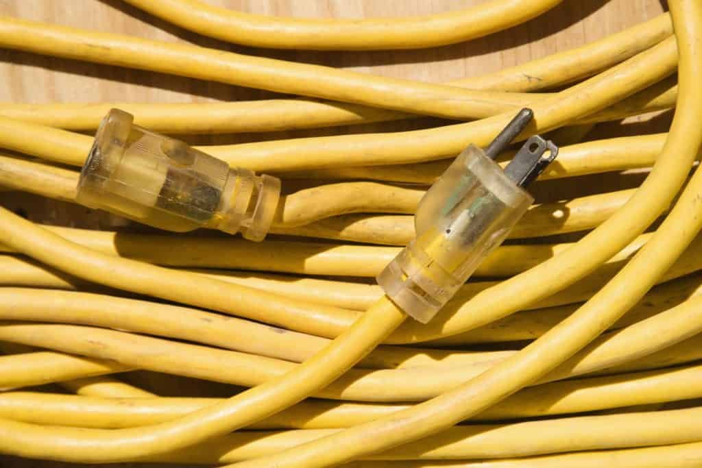 yellow outdoor extension cord bundled up